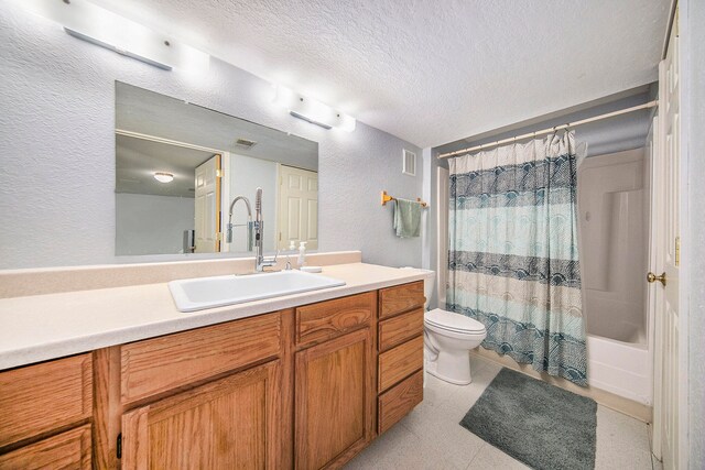 full bathroom with a textured ceiling, shower / tub combo, vanity, and toilet