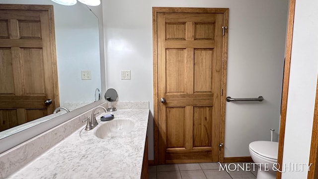 bathroom featuring vanity, toilet, and tile patterned flooring