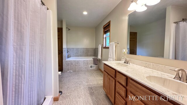 bathroom with plus walk in shower, tile patterned flooring, and vanity