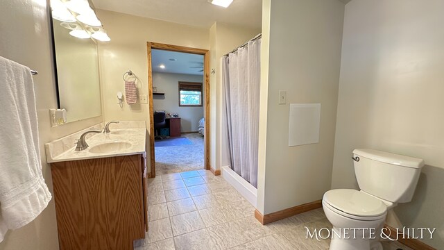 bathroom with curtained shower, tile patterned flooring, toilet, and vanity