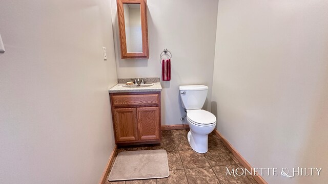 bathroom featuring vanity, toilet, and tile patterned flooring