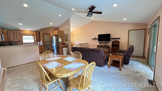 carpeted dining room featuring lofted ceiling and ceiling fan