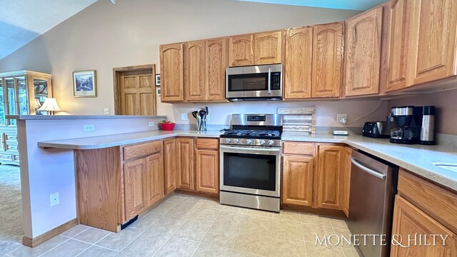 kitchen with high vaulted ceiling, light tile patterned floors, stainless steel appliances, and kitchen peninsula