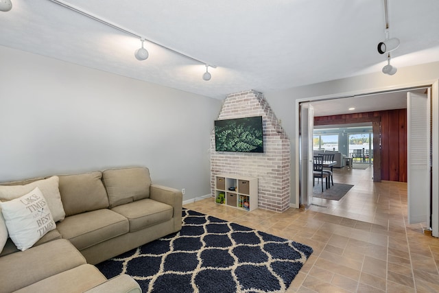 living room with wood walls and track lighting