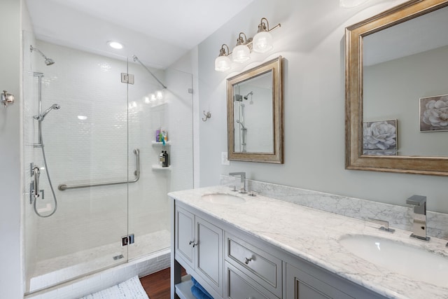 bathroom featuring vanity, hardwood / wood-style flooring, and a shower with shower door