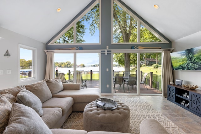 living room featuring high vaulted ceiling and a healthy amount of sunlight