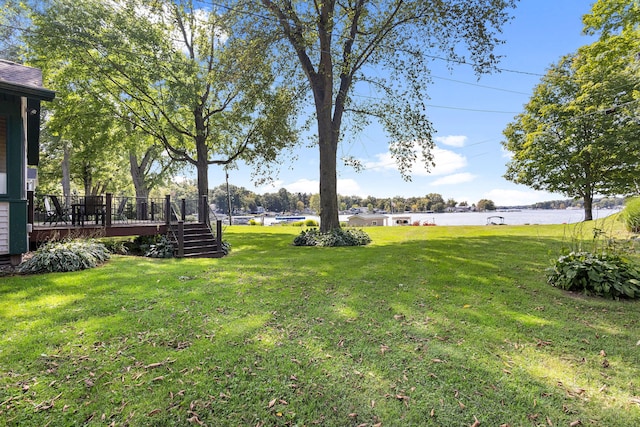 view of yard featuring a deck with water view