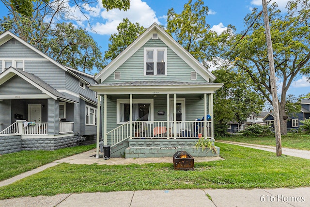 bungalow-style house with a front yard and a porch