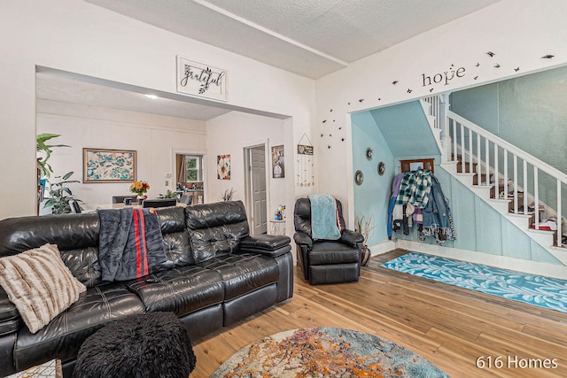 living room with a textured ceiling and light hardwood / wood-style floors