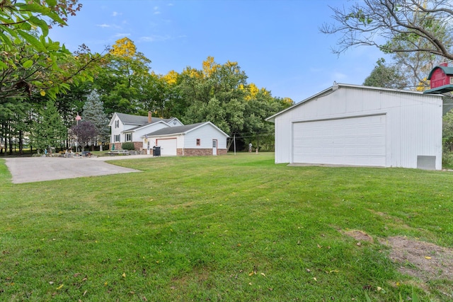 view of yard with a garage and an outdoor structure