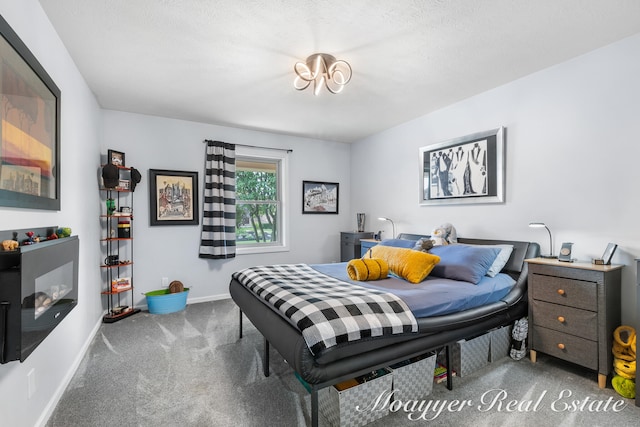 carpeted bedroom featuring a textured ceiling