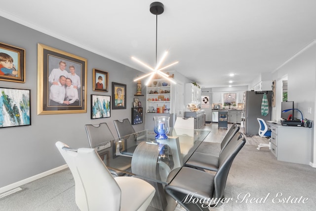 dining room with crown molding and an inviting chandelier