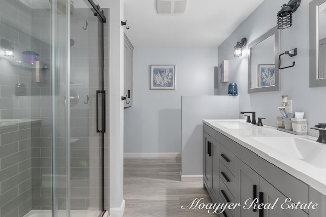 bathroom with vanity, wood-type flooring, and walk in shower