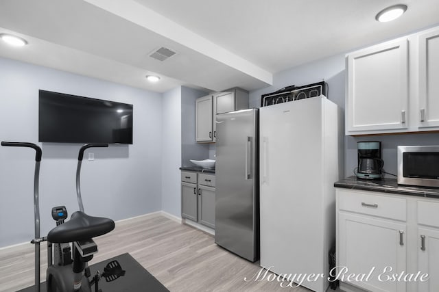 interior space with light hardwood / wood-style flooring and appliances with stainless steel finishes