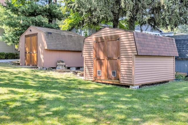 view of outbuilding with a lawn