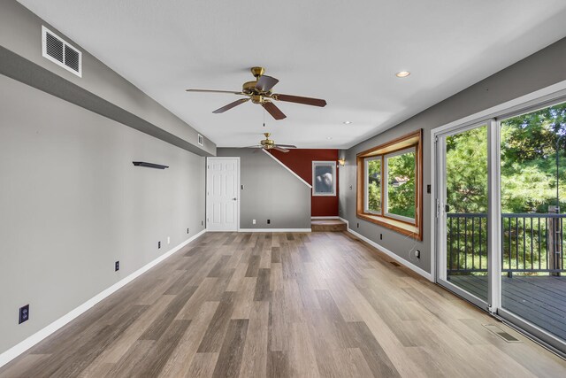 unfurnished living room featuring ceiling fan and light wood-type flooring