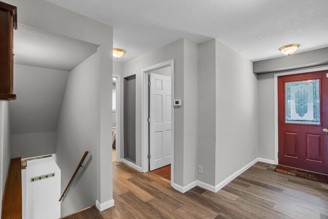 entrance foyer with a textured ceiling and dark hardwood / wood-style floors