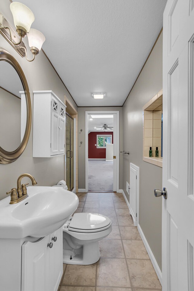 bathroom featuring walk in shower, ceiling fan, sink, tile patterned flooring, and toilet