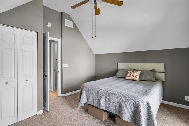 carpeted bedroom with a closet, ceiling fan, and lofted ceiling