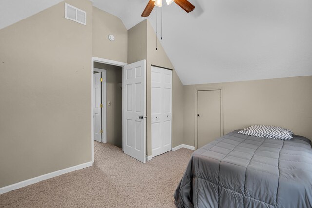 bedroom with light colored carpet, ceiling fan, and lofted ceiling