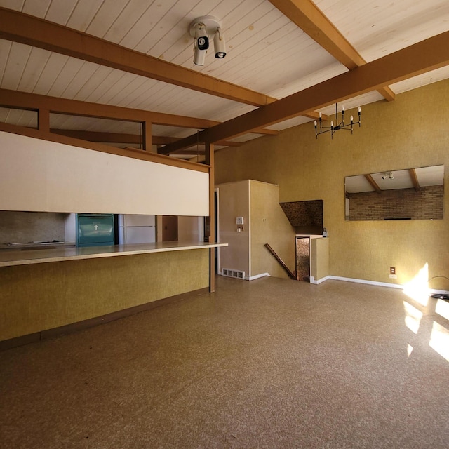 unfurnished living room featuring vaulted ceiling with beams and an inviting chandelier