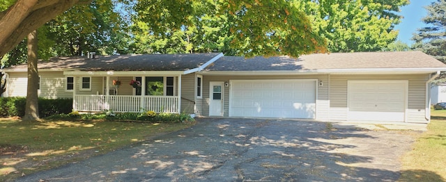 ranch-style house with covered porch and a garage