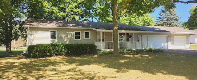 ranch-style home featuring a garage, a front lawn, and covered porch