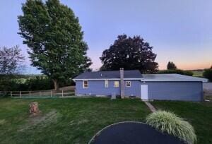 back house at dusk with a yard