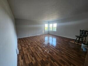 spare room featuring dark wood-type flooring