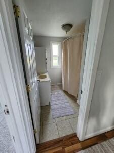 bathroom featuring curtained shower and tile patterned floors