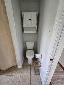 bathroom featuring toilet and tile patterned floors