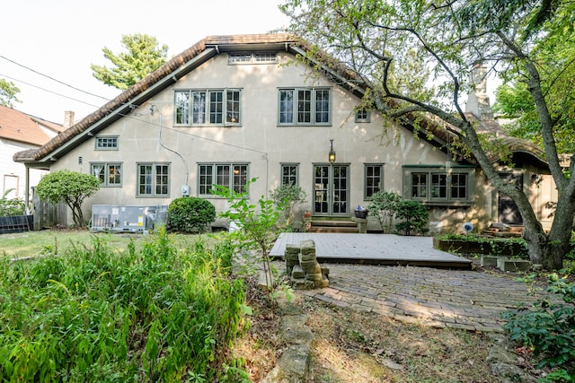 back of property featuring a wooden deck and french doors