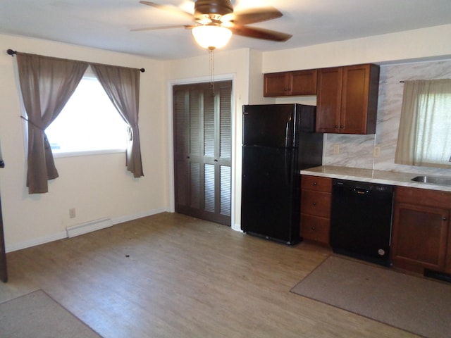 kitchen featuring light wood-type flooring, black appliances, ceiling fan, and sink