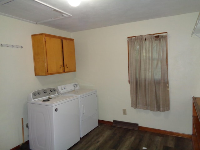 laundry room featuring cabinets, independent washer and dryer, and dark hardwood / wood-style floors