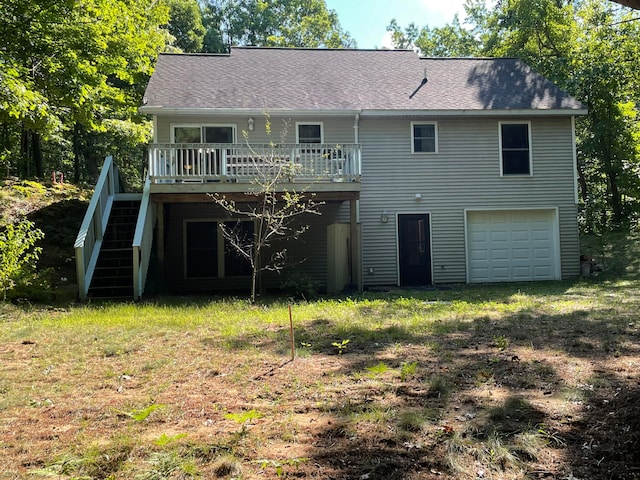 rear view of property featuring a deck and a garage