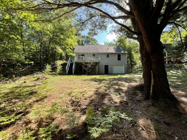 rear view of property featuring a wooden deck