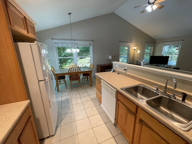 kitchen with white appliances, plenty of natural light, sink, and vaulted ceiling