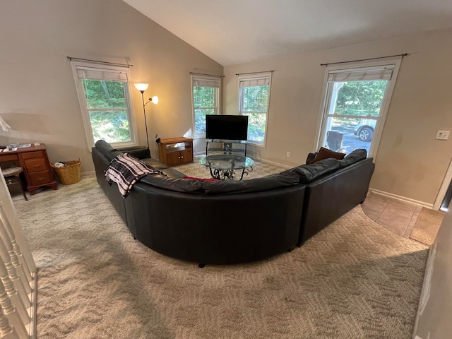 living room featuring plenty of natural light, light colored carpet, and vaulted ceiling