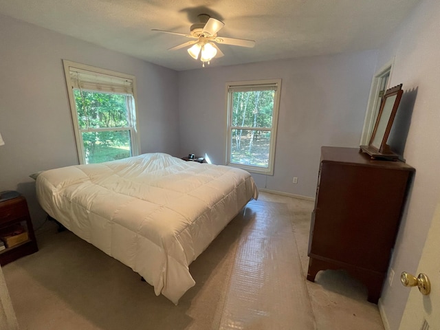 bedroom featuring ceiling fan and a textured ceiling