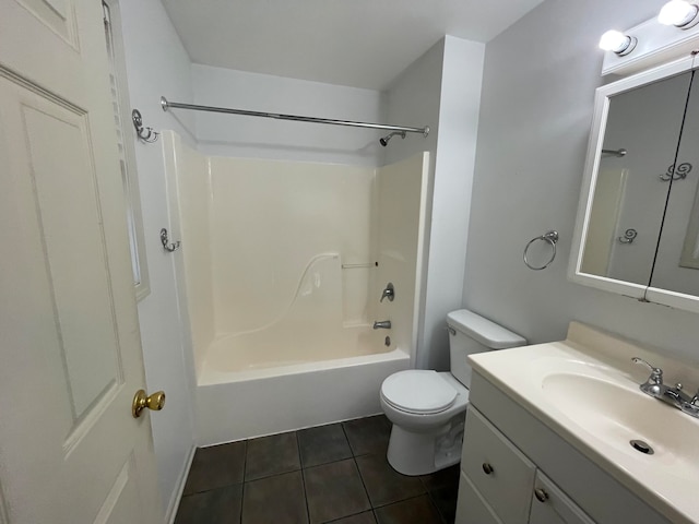 full bathroom featuring toilet, vanity, tile patterned flooring, and  shower combination