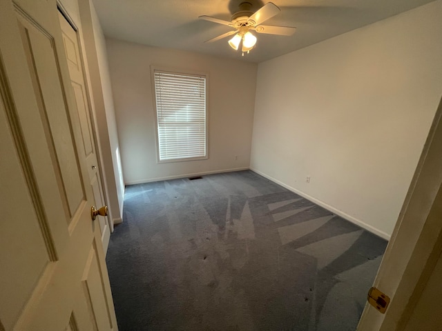 carpeted empty room with ceiling fan