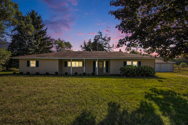 ranch-style house featuring a lawn and a garage