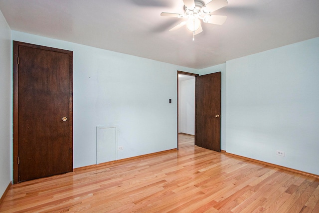 unfurnished room with light wood-type flooring and ceiling fan