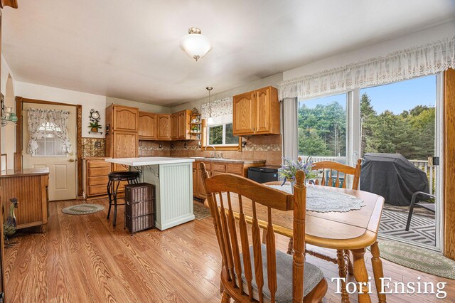 dining area with light hardwood / wood-style floors and sink