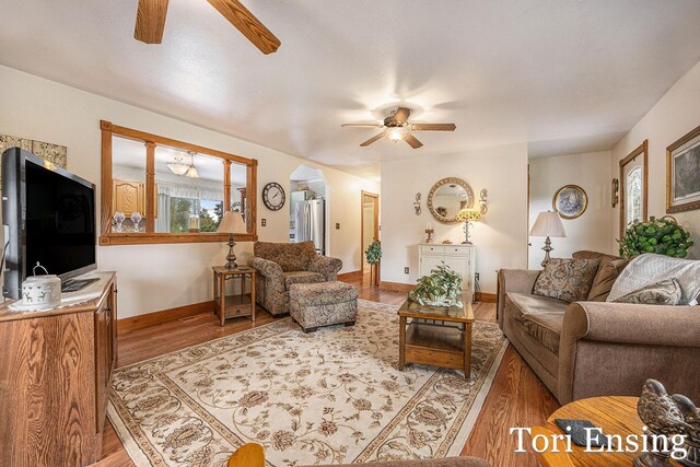 living room featuring hardwood / wood-style floors and ceiling fan