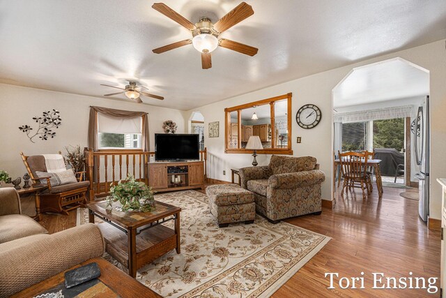 living room featuring hardwood / wood-style floors, ceiling fan, and plenty of natural light