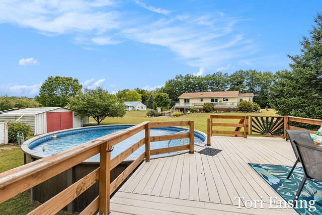 deck featuring a lawn and a storage shed