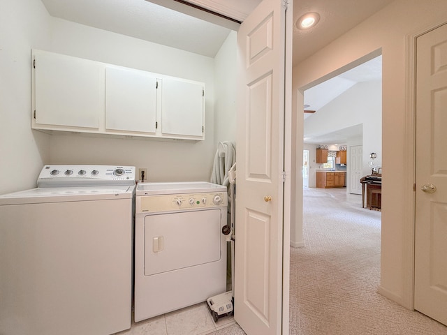 laundry room with cabinets, separate washer and dryer, and light colored carpet