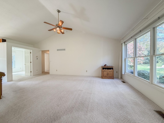 unfurnished living room featuring ceiling fan, high vaulted ceiling, and light colored carpet