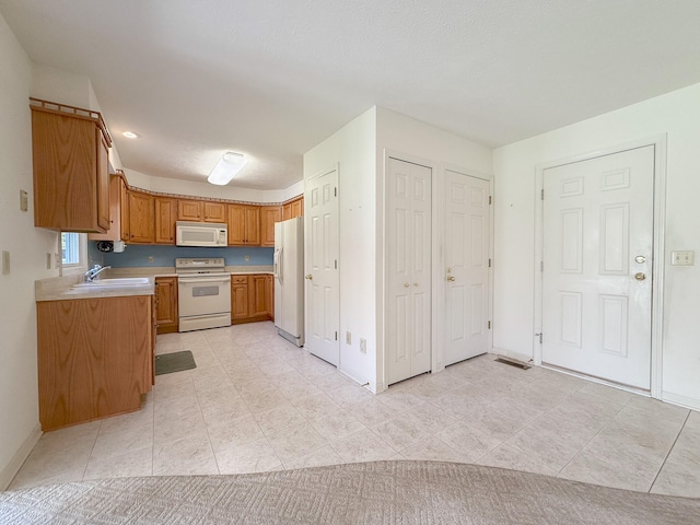 kitchen with sink and white appliances